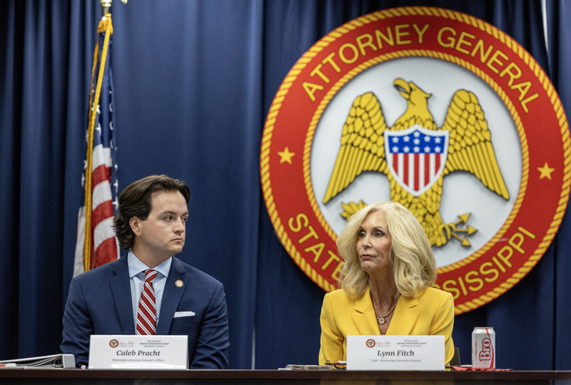 Special Assistant Attorney General Caleb Pracht, left, and Attorney General Lynn Fitch listen as committee members introduce themselves during the first meeting of the Mississippi Opioid Settlement Advisory Committee at the Walter Sillers Building in Jackson, Miss., on Wednesday, July 9, 2025. Credit: Eric Shelton/Mississippi Today