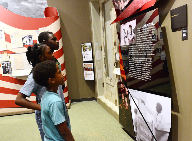 Young people read about the life and death of Emmett Till during a tour the Mississippi Civil Rights Museum, Friday, July 25, 2025, in Jackson. Free tours were offered in honor of Till's birthday. Credit: Vickie D. King/Mississippi Today