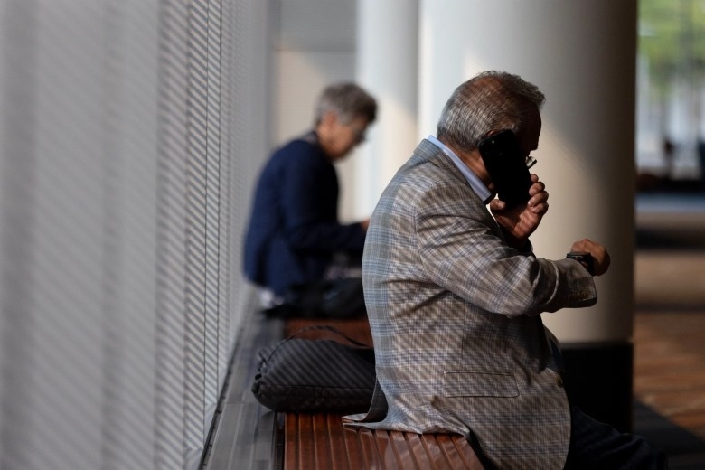 A conference-goer pauses for a phone call outside a panel discussion at the National Conference of State Legislatures annual summit in Boston on August 4, 2025. (Chris Lisinski/SHNS)