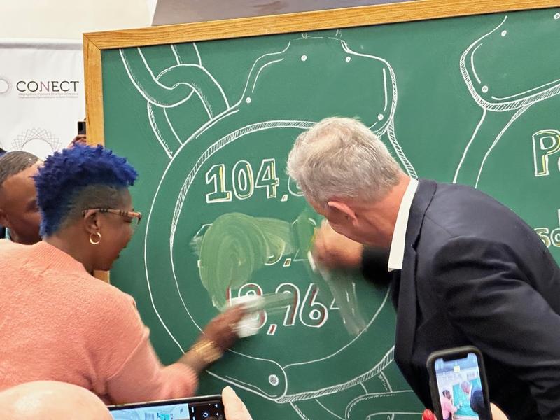 Gov. Ned Lamont and Tammy King erase numbers on a chalkboard, a symbolic gesture to wiping the slate clean in light of Connecticut's "clean slate" law taking full effect. CREDIT: MARK PAZNIOKAS / CT MIRROR