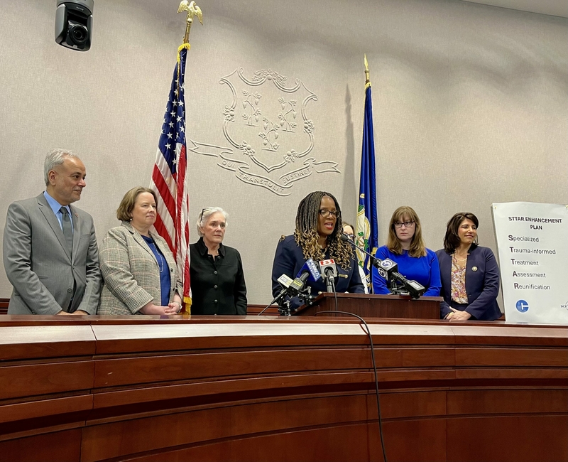 Jodi Hill-Lilly, commissioner-designee for Connecticut's Department of Children and Families, announces policy changes about STAR group homes on Thursday, March 14. State lawmakers stand alongside her as she makes her announcement in Hartford. CREDIT: GINNY MONK / CT MIRROR