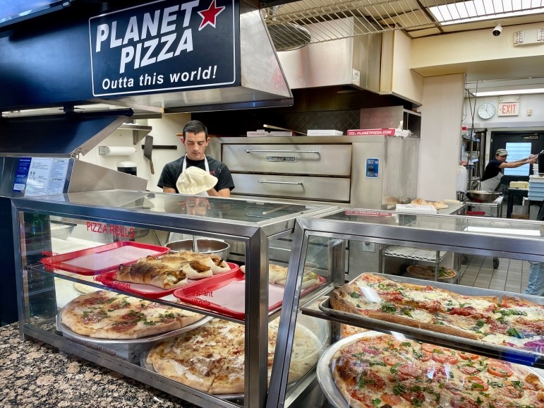 A pizza maker stretches dough at Planet Pizza in Ridgefield on "Shop Small Saturday" in 2023. Credit: Erica E. Phillips / CT Mirror