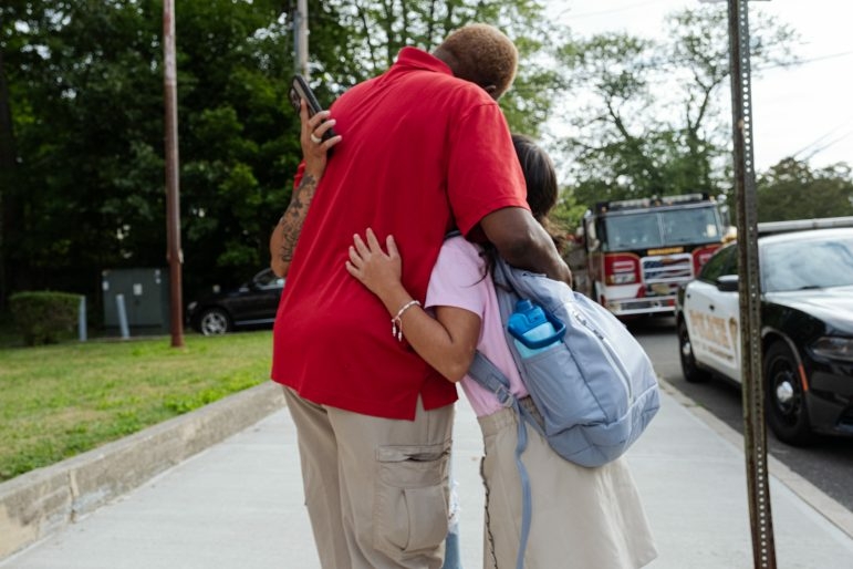 Parents, students, and staff embraced on the first day of school at the Bridgeport Learning Center. Credit: Shahrzad Rasekh / CT Mirror