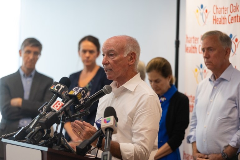 Rep. Joe Courtney discusses the impact of the federal budget bill on Connecticut at a press conference at Charter Oak Health Center in Hartford on July 7, 2025. Courtney was joined by Gov. Ned Lamont, Sen. Richard Blumenthal, Rep. John Larson, and other politicians who condemned the “Big Beautiful Bill.” Credit: Dana Edwards / CT Mirror