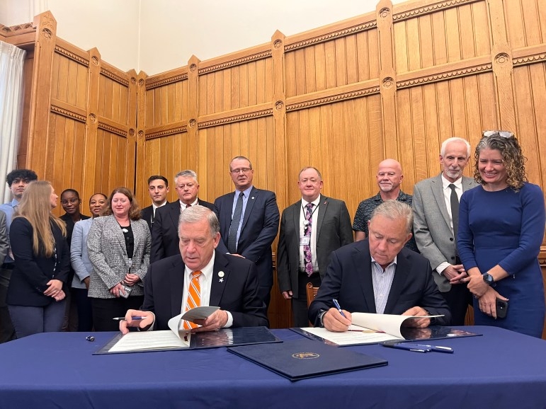 Gov. Ned Lamont, right, sits with Nuclear Regulatory Commission Chairman David A. Wright to sign an agreement transferring oversight of certain radioactive materials to state officials.