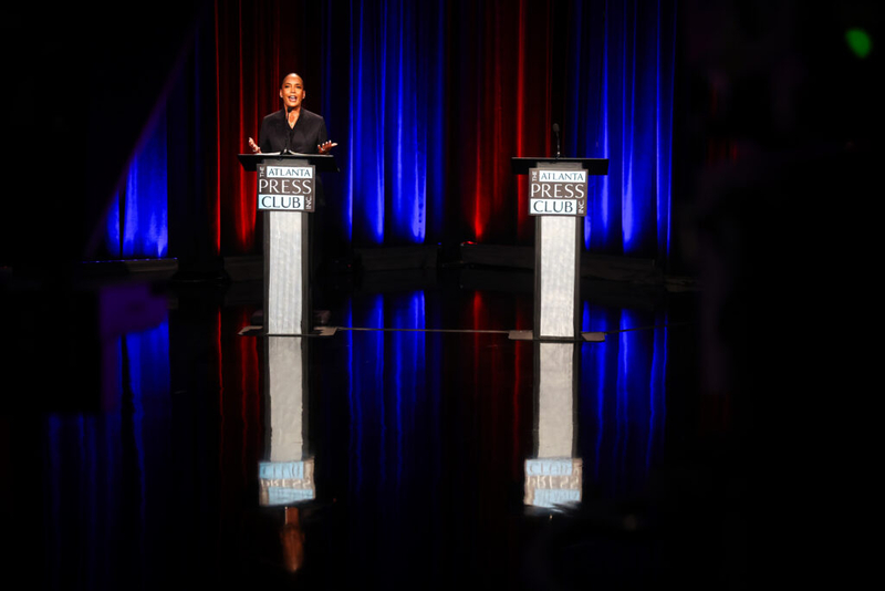 Bottoms faces empty podium on debate stage while Jackson campaigns with Kemp