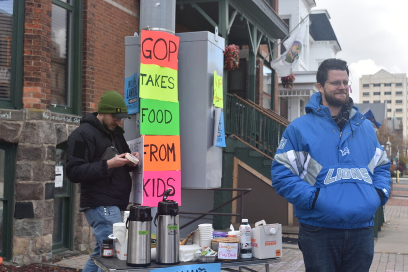 Congressional candidate hosts food drive and vigil outside Rep. Tom Barrett’s Lansing office