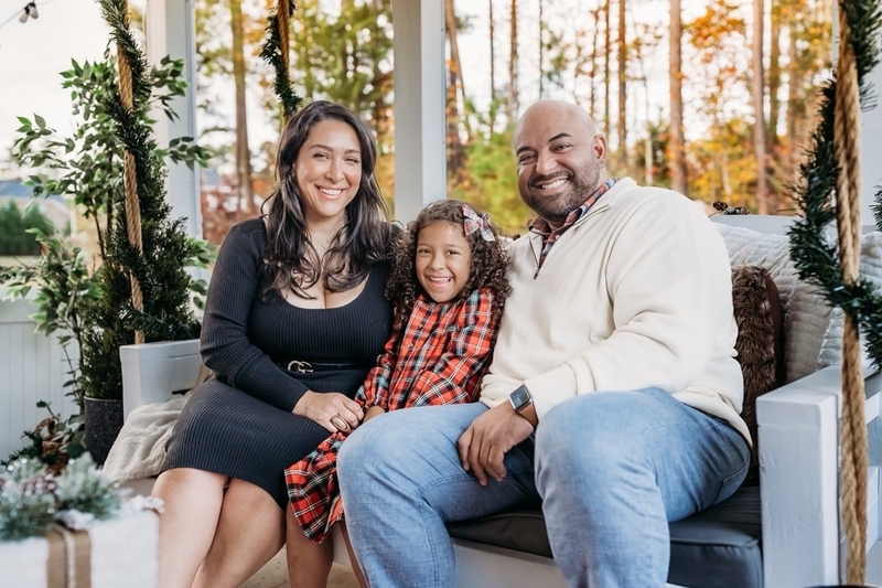 A woman and her husband and their daughter.