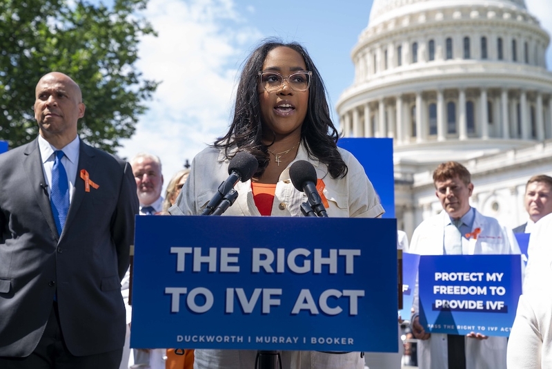 A woman speaks before the U.S. Capitol.