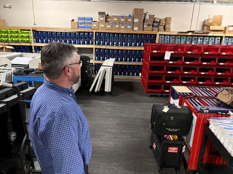 Douglas County, Kan., Clerk Jamie Shew, a Democrat, surveys election-related material at a county office space. Shew said a proof of citizenship voter registration requirement could require him to hire additional staff.
