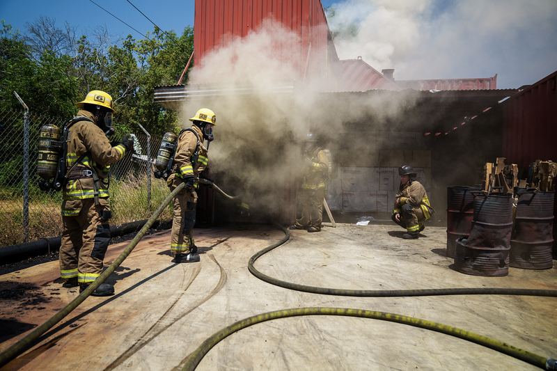 Firefighters work to put out a fire in shipping containers during a training session.