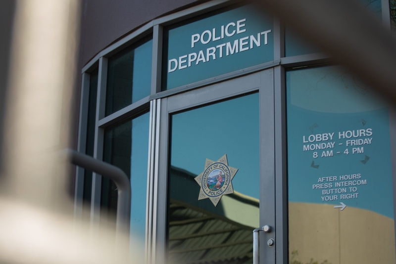 The front door of a police deparment's building. The door includes the words "police department" along with the seal of the University of California police.