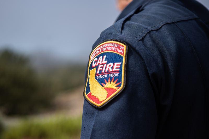 A close-up view of a patch switched onto the left shoulder of a fire officers blue inform.