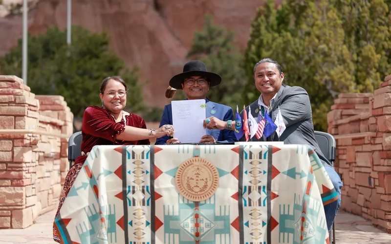 Navajo Nation Council Speaker Crystalyne Curley (left), President Buu Nygren (center) and Delegate Casey Allen Johnson (right) hold a resolution signed on April 29, 2024 asking President Joe Biden to halt the transportation of uranium ore through the reservation.