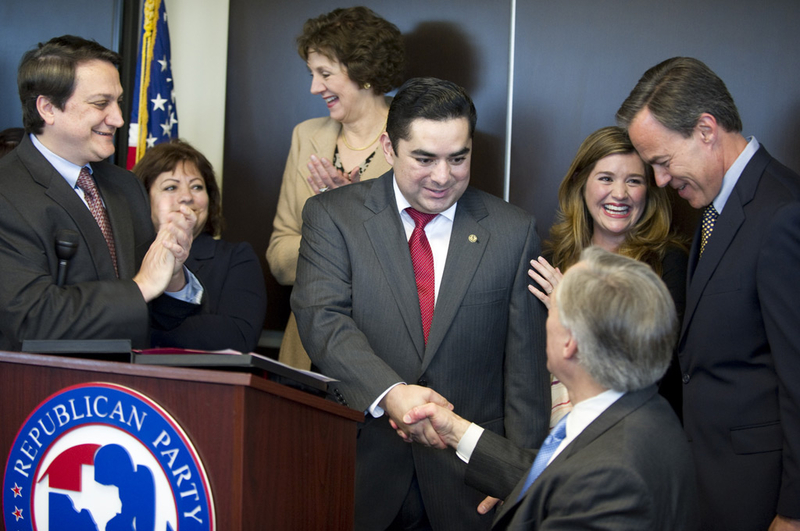 State Rep. J.M. Lozano of Kingsville (center) shakes hands with Attorney General Greg Abbott as he announces that he's switching to the Republican Party during a press conference Thursday, March 18, 2012.