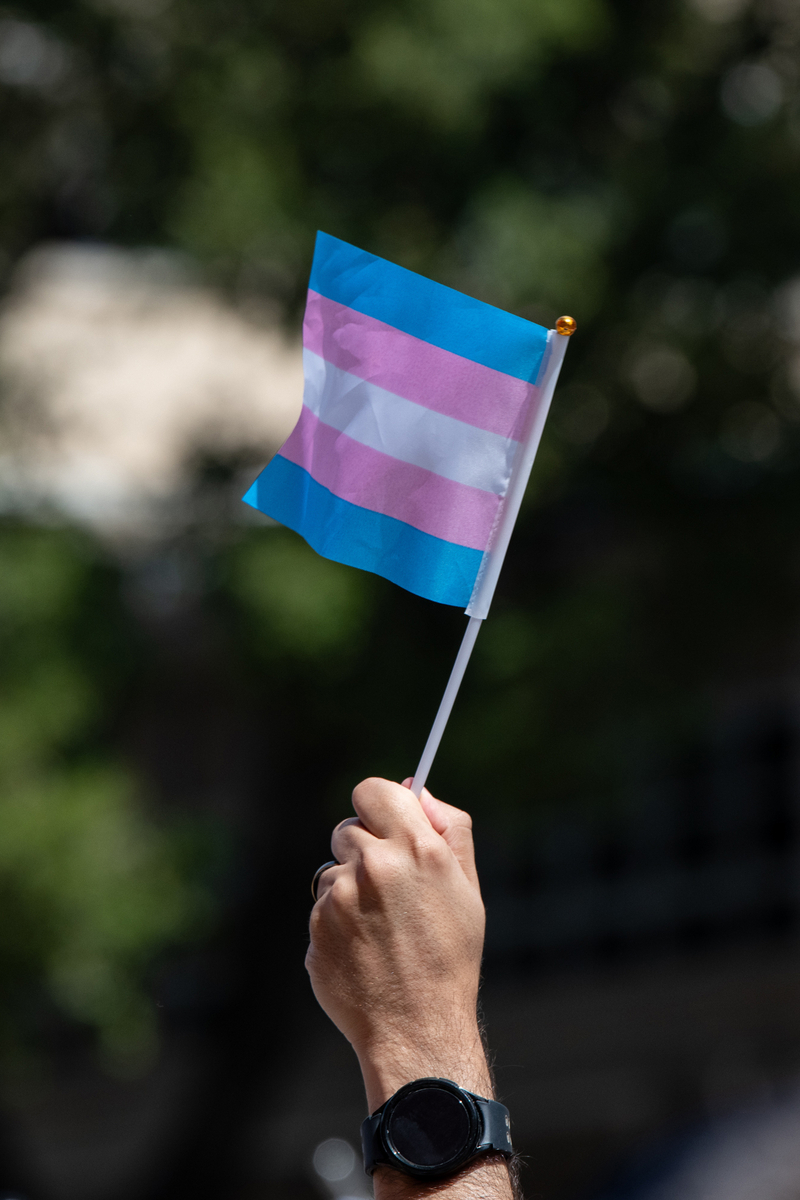 An attendee waves a trans flag while marching with over 300 activists and supporters from the Bexar County Courthouse to Crockett Park in “March for Us,” San Antonio's third annual celebration of Transgender Day of Visibility, on Saturday, March 29, 2025 in San Antonio, Texas.