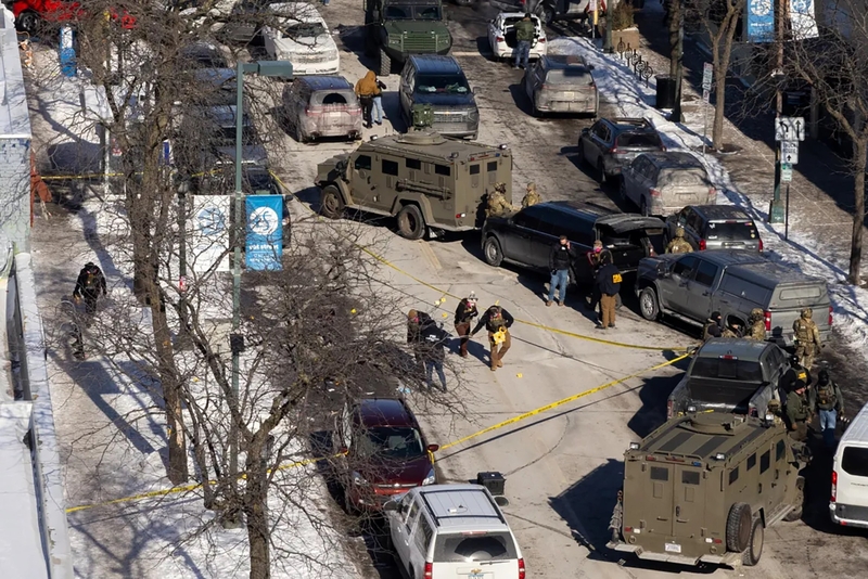 FBI agents work at the scene of the Pretti shooting.