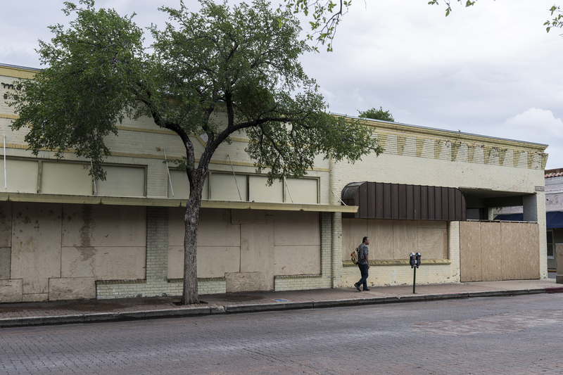 A block of storefronts in downtown Laredo is boarded up on April 9, 2026.