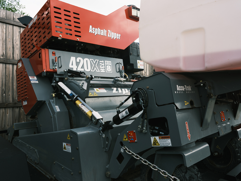 Wallingsford explained: “That is what our guys do probably eight months out of the year. They use this zipper machine here to eat up the old asphalt. Then we compact it with a rolling machine over there, and then we come back and chip seal the existing roads. It’s a cheaper way of getting the potholes out of the roads and giving the citizens a smoother surface to drive on.” The equipment was purchased in a bond election to save the city money by paying outside contractors to repave the city’s street