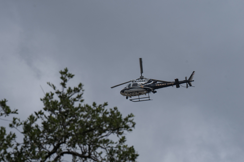 A Texas Department of Public helicopter flies over Uvalde on July 15, 2026, as floodwaters rise across the city.