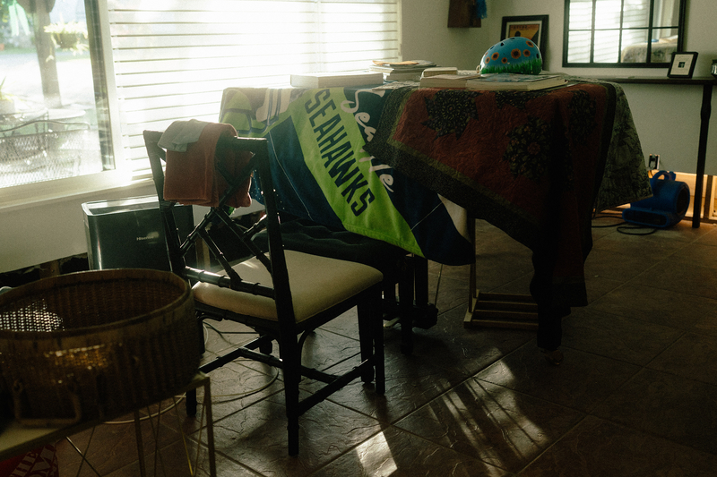 Joan Connor’s piano, which she bought to replace the piano she lost on the July 4, 2025 flood, is covered with blankets and exposed to a dehumidifier to keep it from further damage after the most recent flood. On July 26, 2026 in Hunt, Texas.