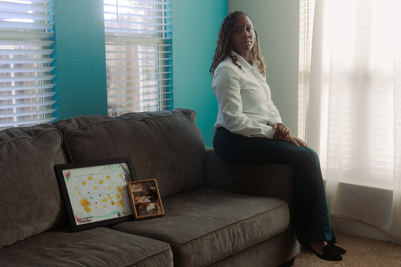 Ronda Young, a surrogate mother of three children, with a piece of art one of her surrogate children, PG, made for her at three years old and a photo of them together, at her home in Glenn Heights on August 24, 2026.