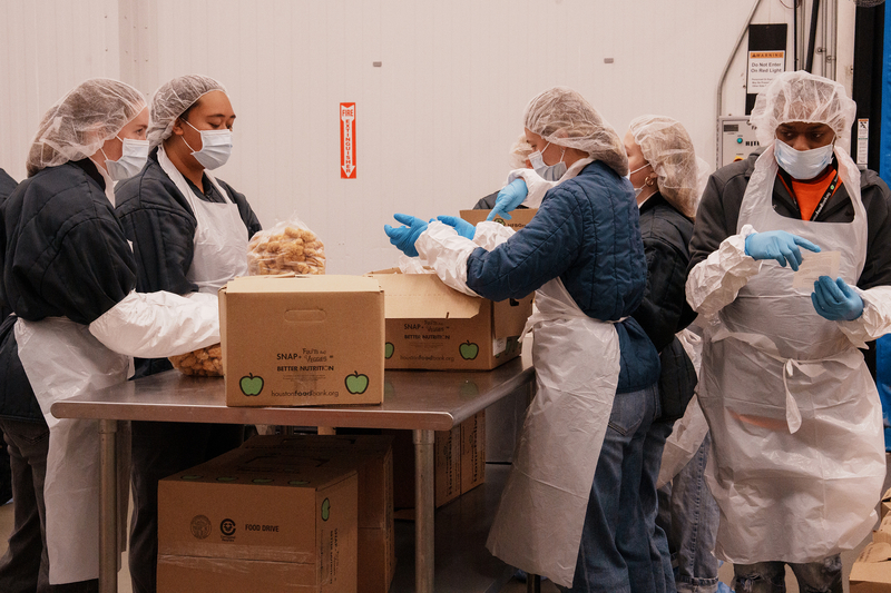 Volunteers sort and prepare food in the protein pack room at Houston Food Bank in Houston on Aug. 12, 2026.