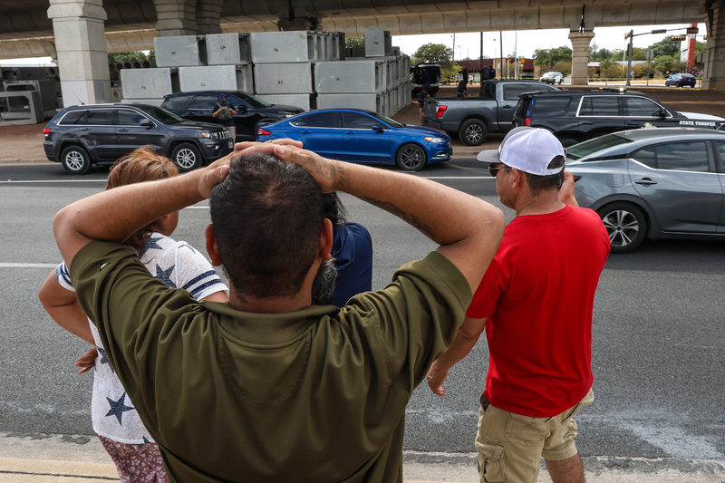 Onlookers observe the scene of the shooting in North Austin on Sunday afternoon, Sept. 20, 2026.