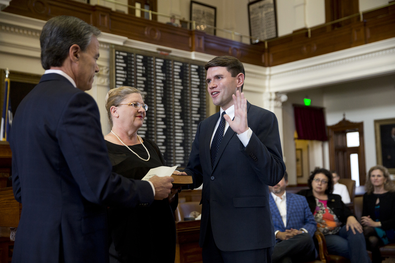 Texas House Speaker Joe Straus swears in Rep. James Talarico while Talarico's mother Tamara holds a bible on Nov. 20, 2018