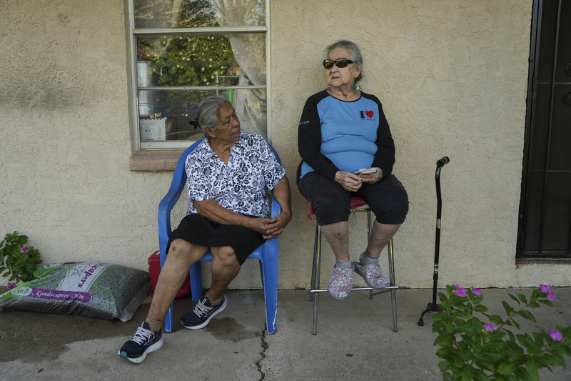Maria Gomez, 78, “Doña Mary,” left, and her friend Teresa Corona Garza, 80, talk to each other at Corona’s home in San Juan on Oct. 9.