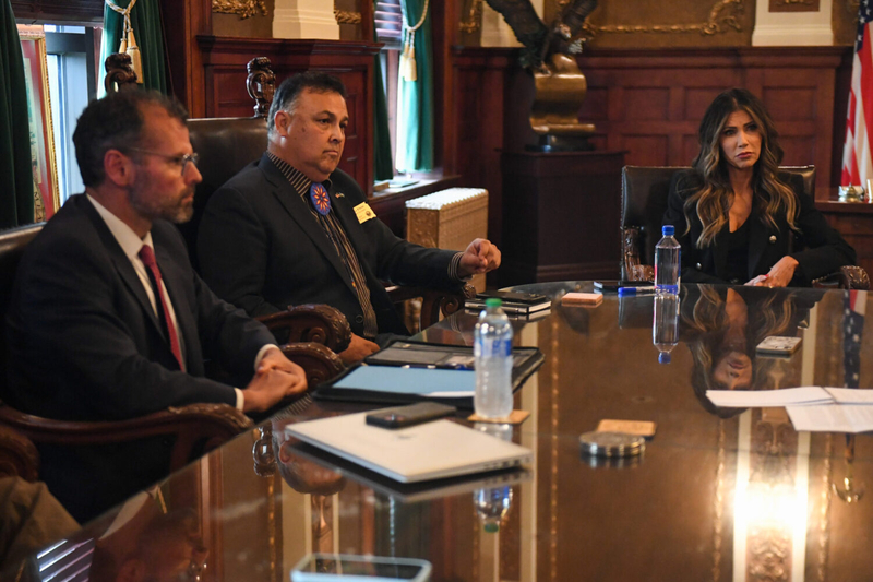 From left, South Dakota Department of Social Services Secretary Matt Althoff, Department of Tribal Relations Secretary David Flute and Gov. Kristi Noem speak with the Argus Leader and South Dakota Searchlight in Noem's office at the South Dakota Capitol in Pierre on Sept. 26, 2023. (Samantha Laurey/Argus Leader)