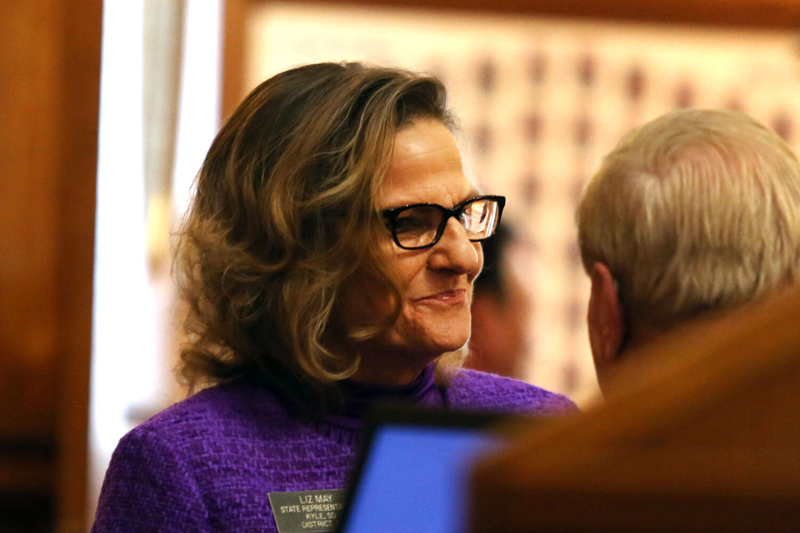 Rep. Liz May, R-Kyle, talks with other legislators on the House floor before Gov. Kristi Noem&amp;#039;s budget address on Dec. 5, 2023. (Makenzie Huber, South Dakota Searchlight)