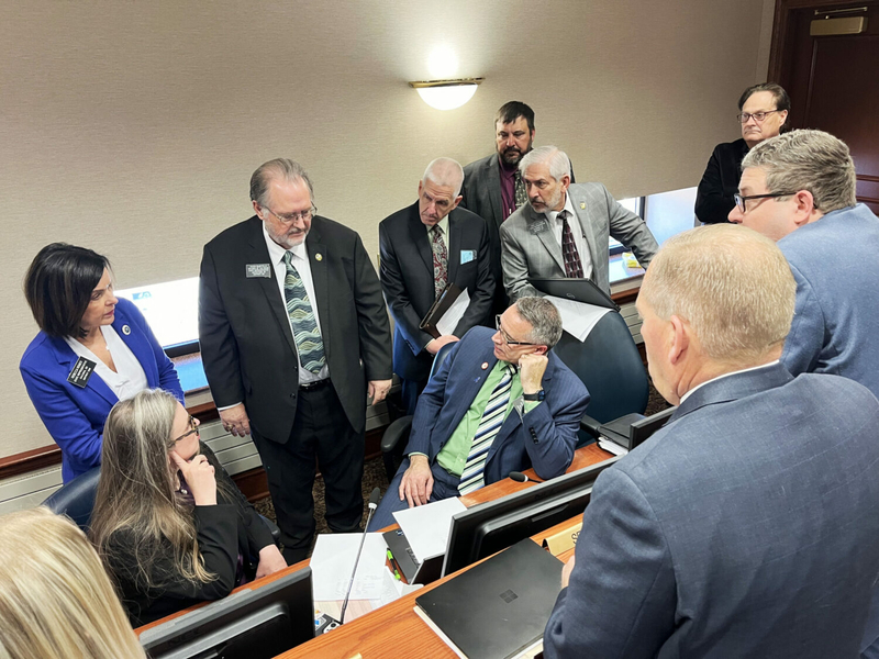 Lawmakers, education lobbyists and education officials gather together during a conference committee on the teacher pay bill to discuss the issue. (Makenzie Huber/South Dakota Searchlight)