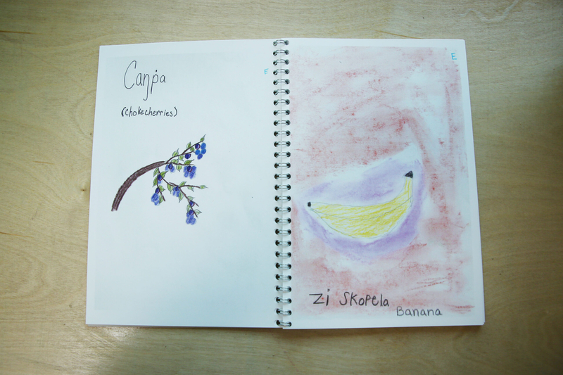 A Lakota Waldorf student-made book translates English words into Lakota. The books are used to teach Lakota to students. Lakota Waldorf is located in Kyle, South Dakota on the Pine Ridge Reservation. (Makenzie Huber/South Dakota Searchlight)