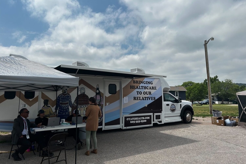The Oyate Health Center serves Native Americans in Rapid City and surrounding areas. The center’s response to the measles outbreak has included hosting mobile vaccine clinics like this one outside the community center of a predominantly Native American neighborhood. (Arielle Zionts/KFF Health News)