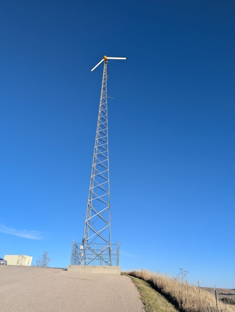 A wind turbine stands outside the KILI radio station near Porcupine, South Dakota. (Photo by John Hult/South Dakota Searchlight)