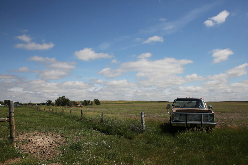 South Dakota Gov. Larry Rhoden drives his 1986 Chevy Silverado on his Union Center ranch on June 26, 2026. (Photo by Makenzie Huber/South Dakota Searchlight)