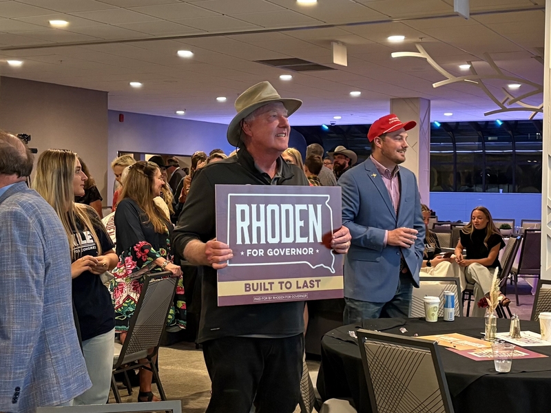 Rep. Mike Derby, R-Rapid City, holds a sign in support of Republican Gov. Larry Rhoden at Rhoden's Primary Election watch party in Rapid City, South Dakota, on June 2, 2026. (Photo by Meghan O'Brien)