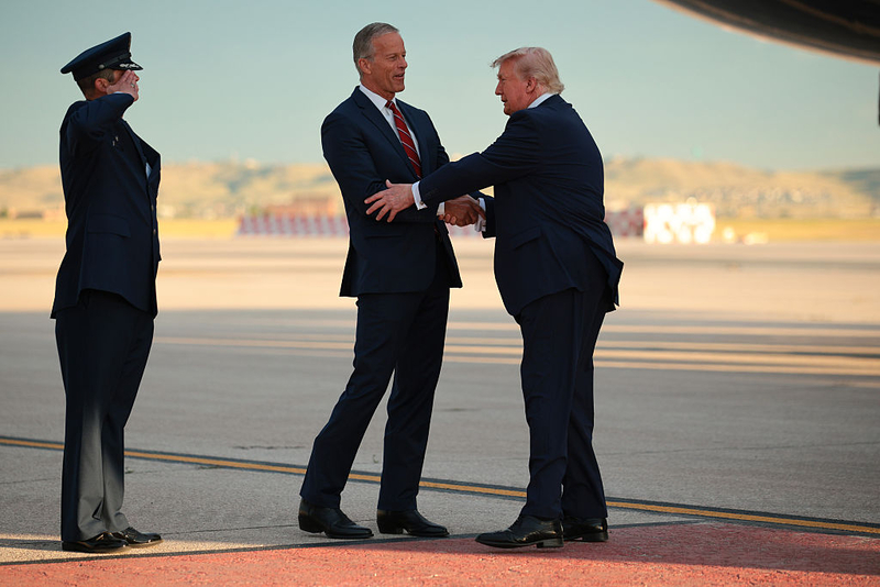 President Donald Trump is greeted by U.S. Senate Majority Leader John Thune, R-South Dakota, on the tarmac after landing in Air Force One on July 3, 2026, at Ellsworth Air Force Base near Rapid City. Trump spoke before a fireworks show at Mount Rushmore, kicking off a weekend of 250th Independence Day celebrations across the country. (Photo by Chip Somodevilla/Getty Images)