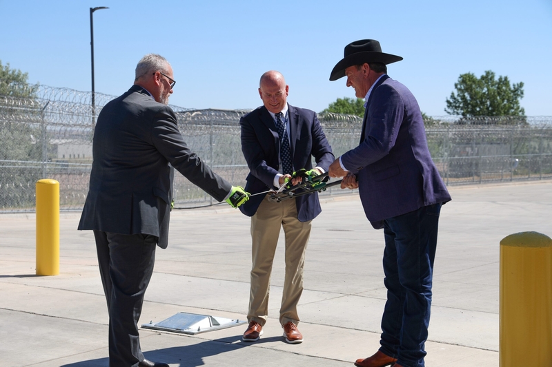 From left, South Dakota Corrections Secretary Nick Lamb, Warden Eric Aldridge and Gov. Larry Rhoden cut a razor wire at an event to mark the completion of an $87 million women's prison in Rapid City. (courtesy Gov. Larry Rhoden's office)