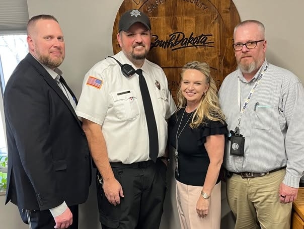 From left, former South Dakota State Penitentiary Warden Joe Roemmich, Maj. Jarod Hettich, former Director of Prison Operations Amber Pirraglia and Corrections Secretary Nick Lamb pose in a social media photo posted in February to congratulate Hettich on a promotion. (South Dakota Department of Corrections photo)