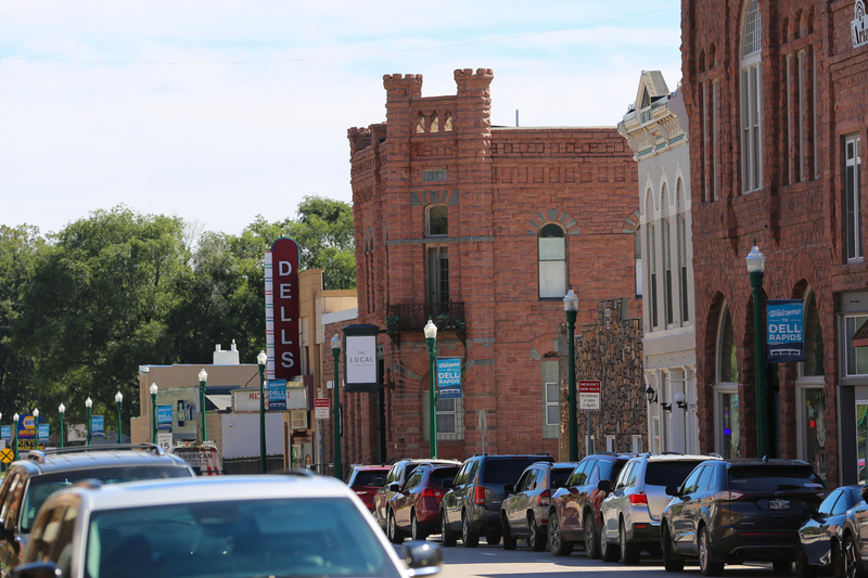Cars parked along a main roadway in Dell Rapids, South Dakota. (Photo by Meghan O'Brien/South Dakota Searchlight)