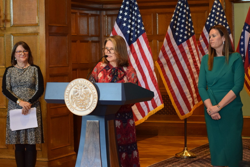 Arkansas Department of Human Services Secretary Kristi Putnam discusses the state's waiver request for Medicaid work requirements on Jan. 28, 2025 as State Medicaid Director Janet Mann (left) and Gov. Sarah Huckabee Sanders listen. (Photo by Antoinette Grajeda/Arkansas Advocate)