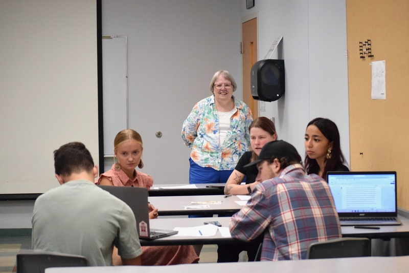 Debbie Miller, a journalism instructor at NorthWest Arkansas Community College in Bentonville, watches as a student shares a video during a discussion on Sept. 11 on Sept. 3, 2026.