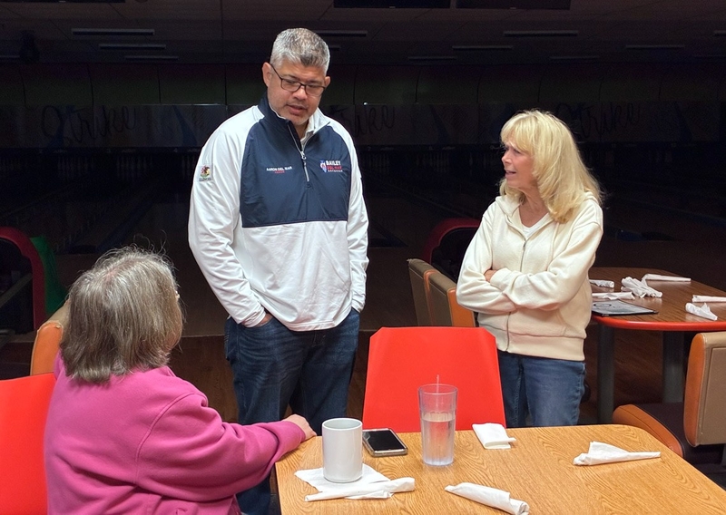 Aaron Del Mar talks with supporters.