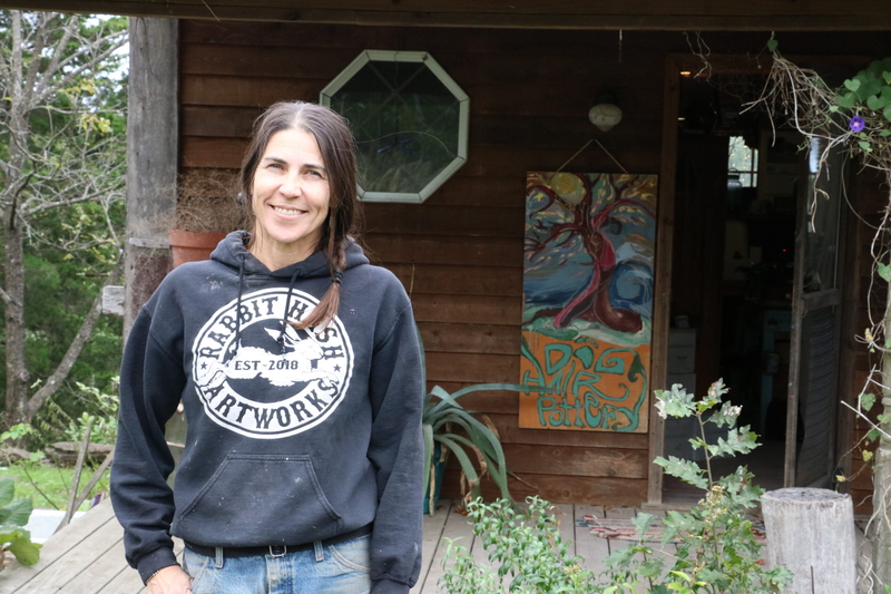 Eliza stands in front of her studio.