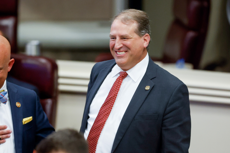 A man in a suit smiling