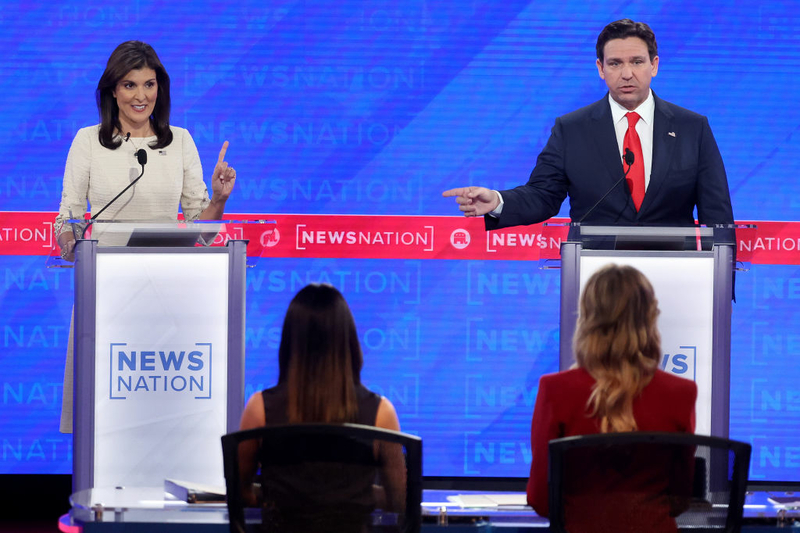 Former Gov. Nikki Haley of South Carolina and Gov. Ron DeSantis gesture from behind two lecterns.