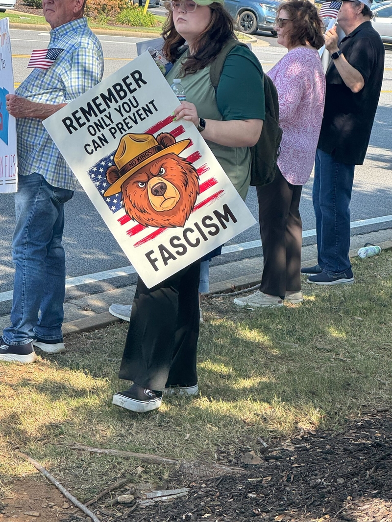 A protestor holds a sign saying "Remember: Only you can prevent fascism"