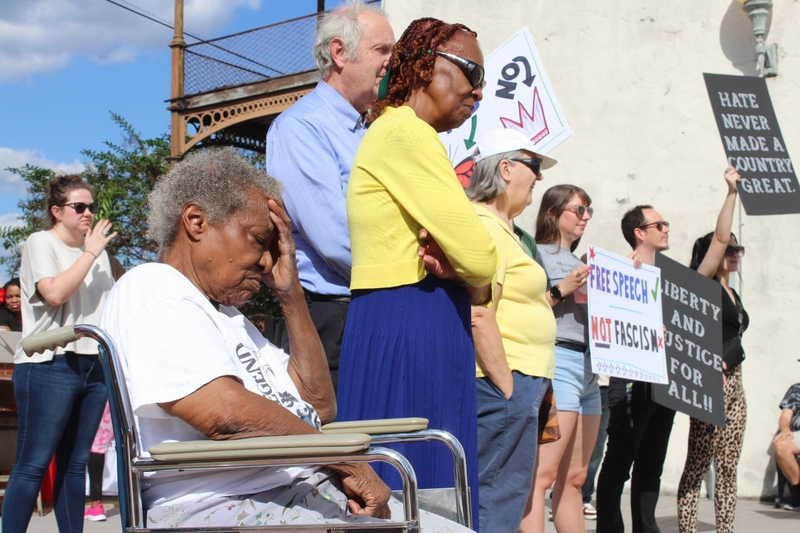 A woman in a wheelchair with her head in her hand